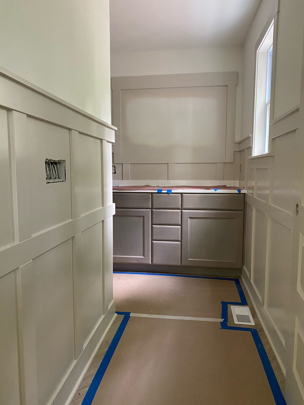 Bathroom vanity area with custom cabinetry and trim
