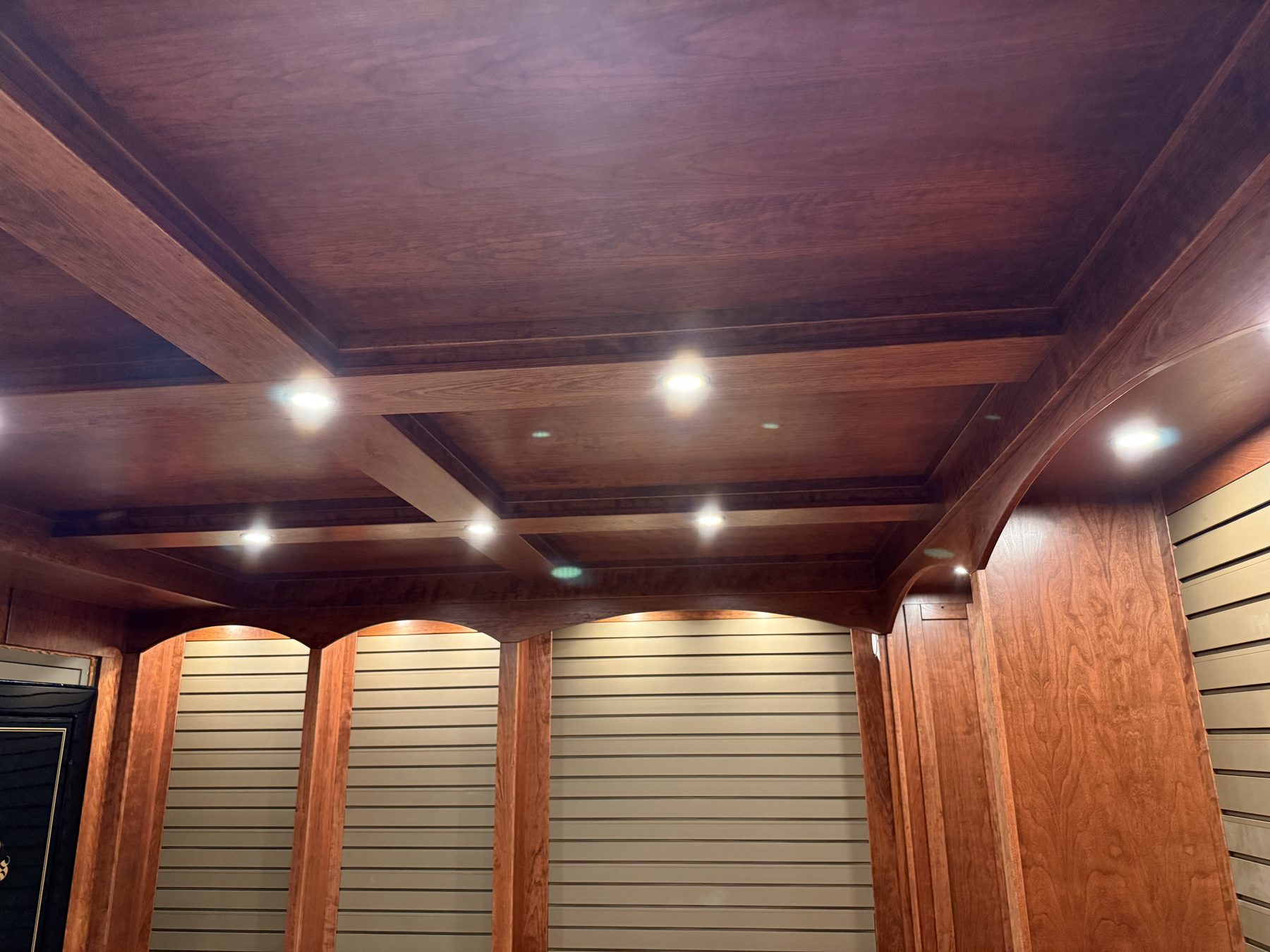 Stained wood cabinetry and ceiling finish detail