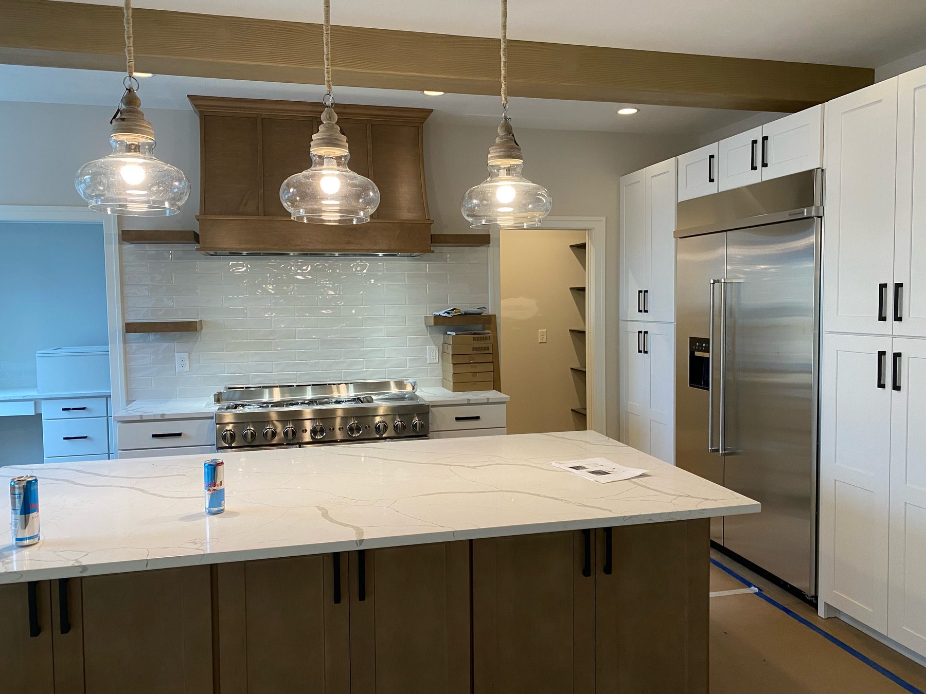 Custom kitchen cabinetry with island and appliance wall