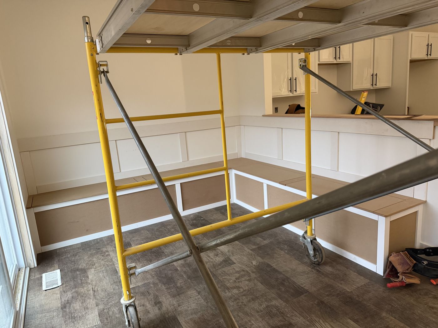 Banquette boxes being built in place under scaffolding