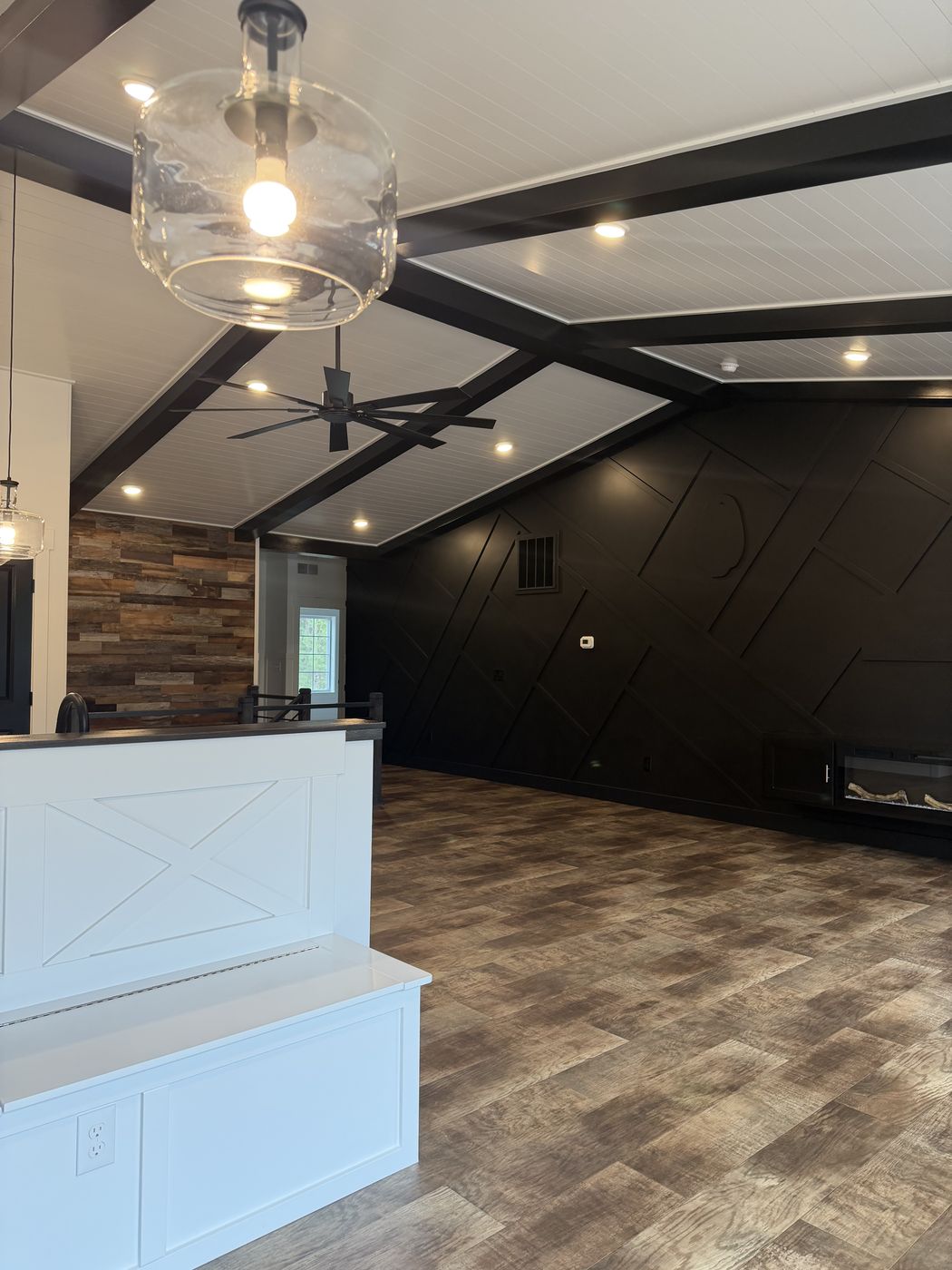 White X-panel banquette end with black diagonal feature wall behind