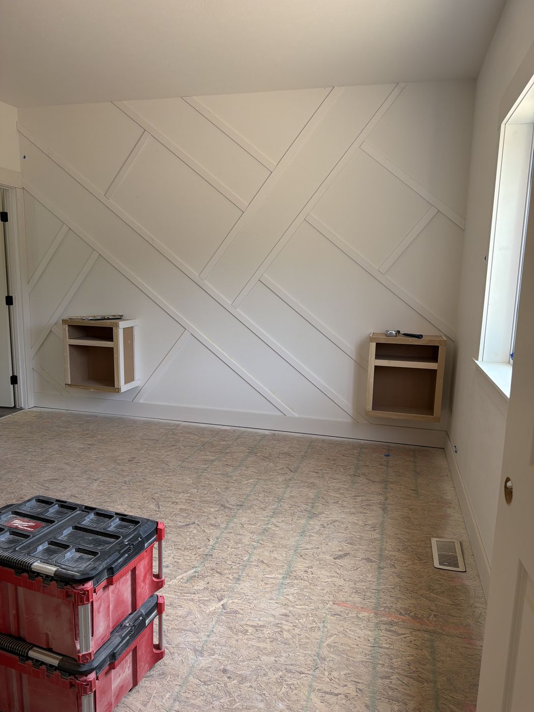 Before: Angled batten wall in primed white with two wall niches