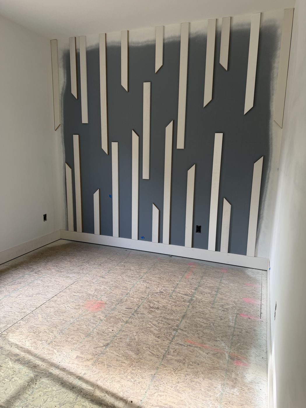 Before: Geometric batten accent wall in a bedroom during painting