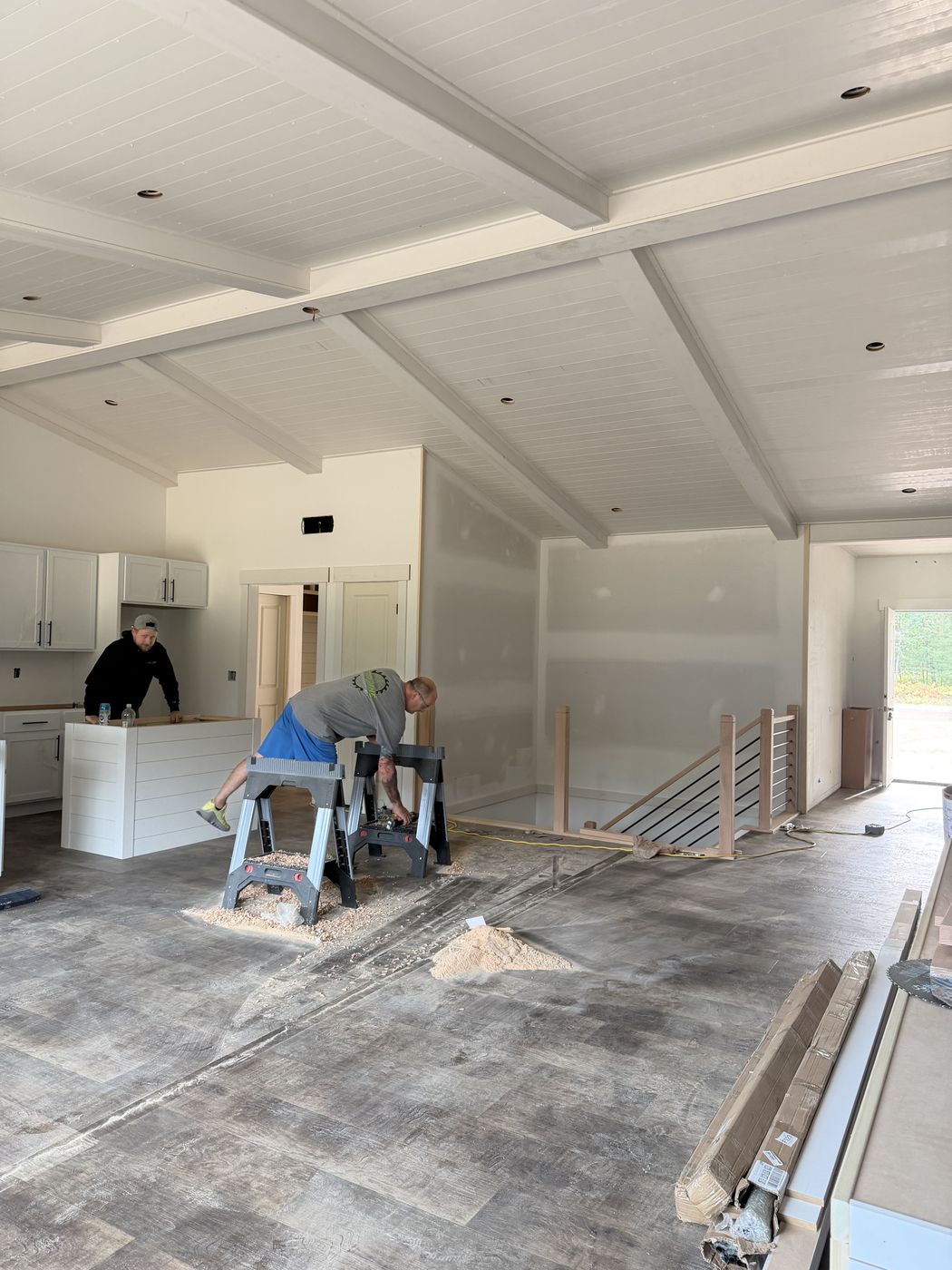 Dakota Robinson at the kitchen island and Larry Robinson at the sawhorses during trim-out