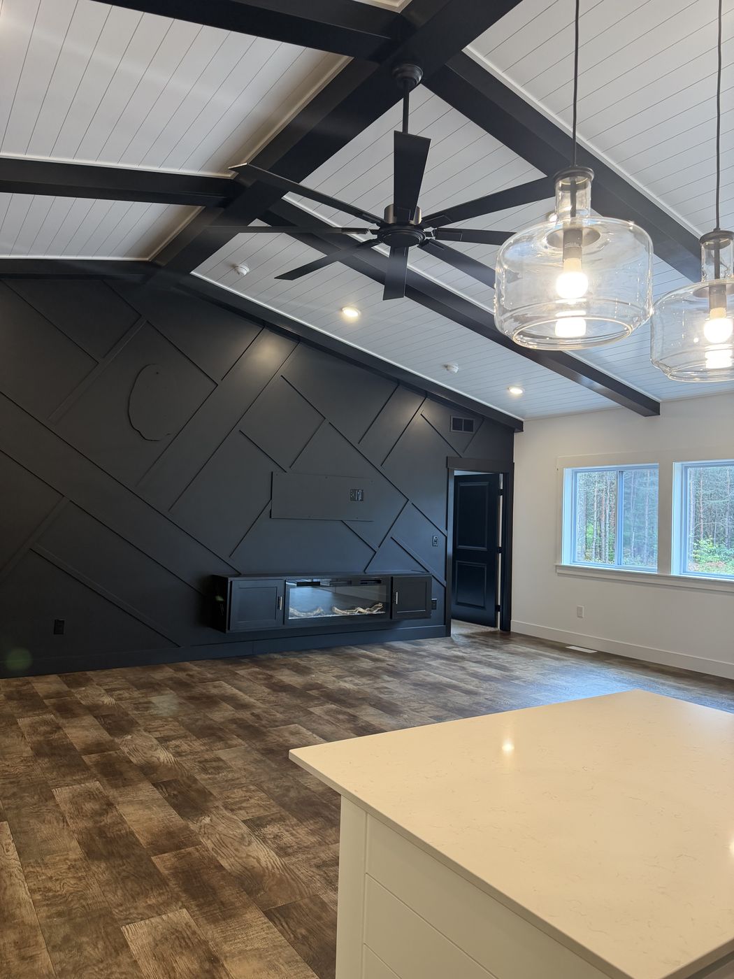 After: Finished black diagonal batten feature wall with fireplace in the great room