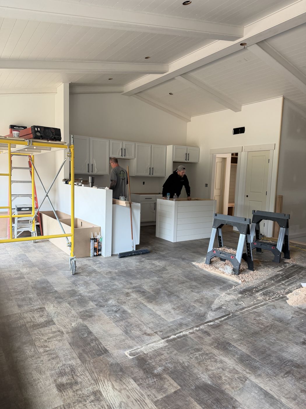 Larry and Dakota Robinson working on the kitchen island and banquette