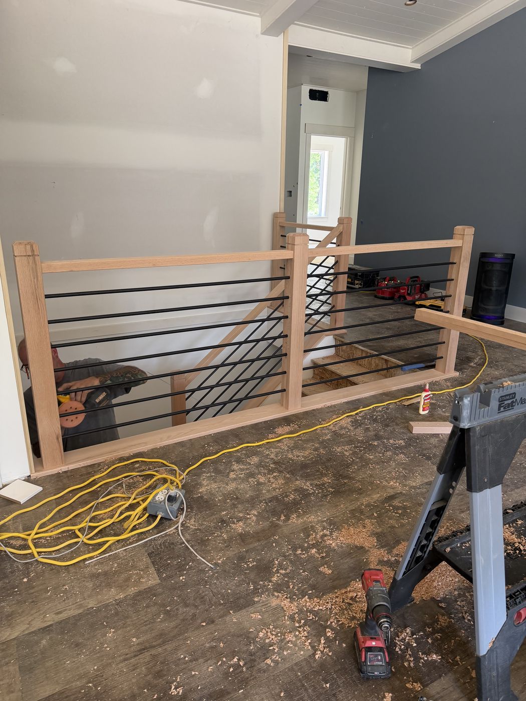 Stair rail posts and bars laid out during installation