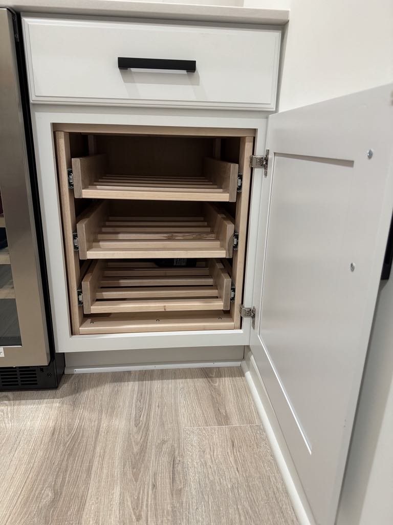 Custom pull-out trays inside kitchen cabinetry