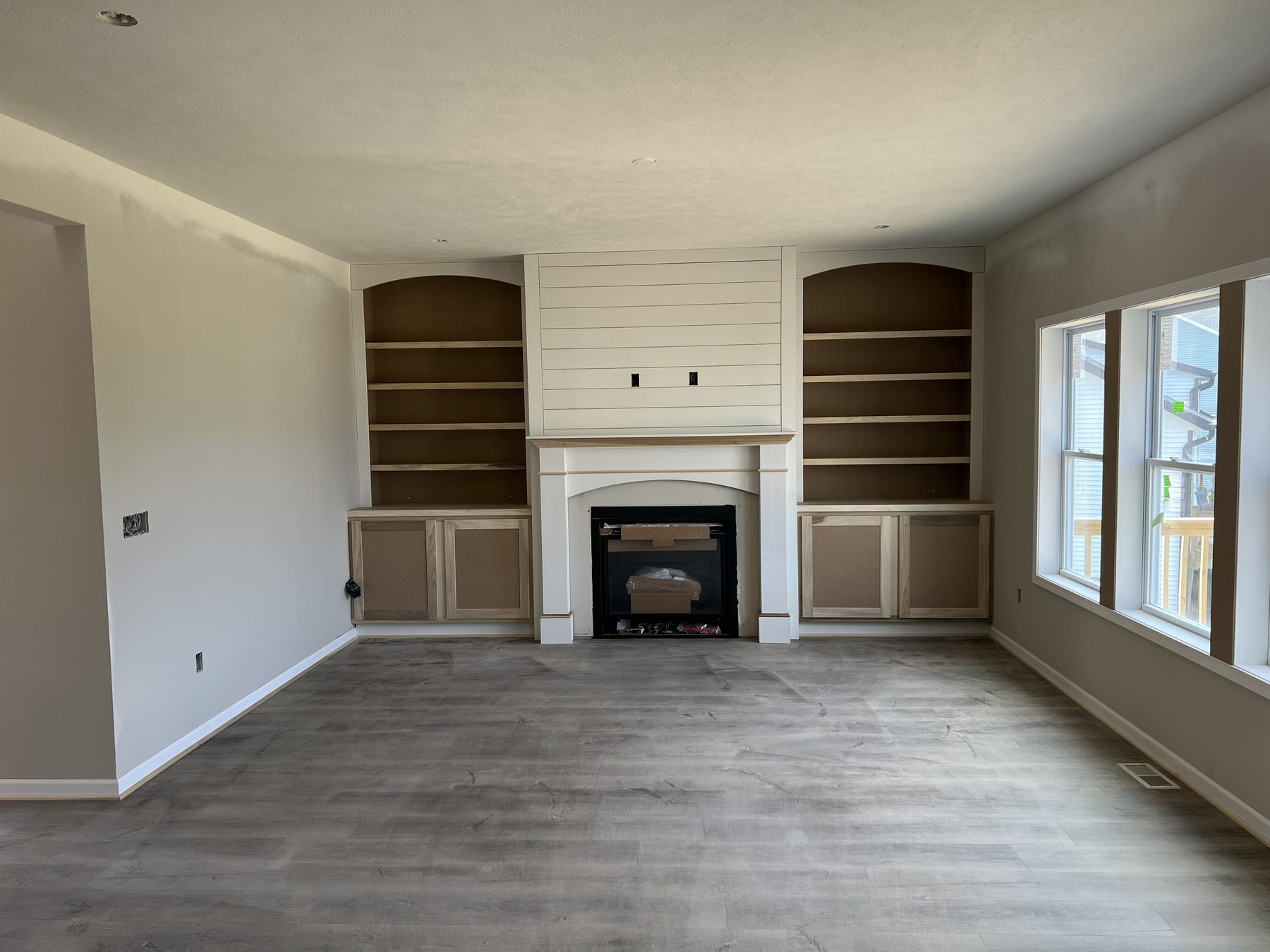 Fireplace wall with built-in shelving and finish trim