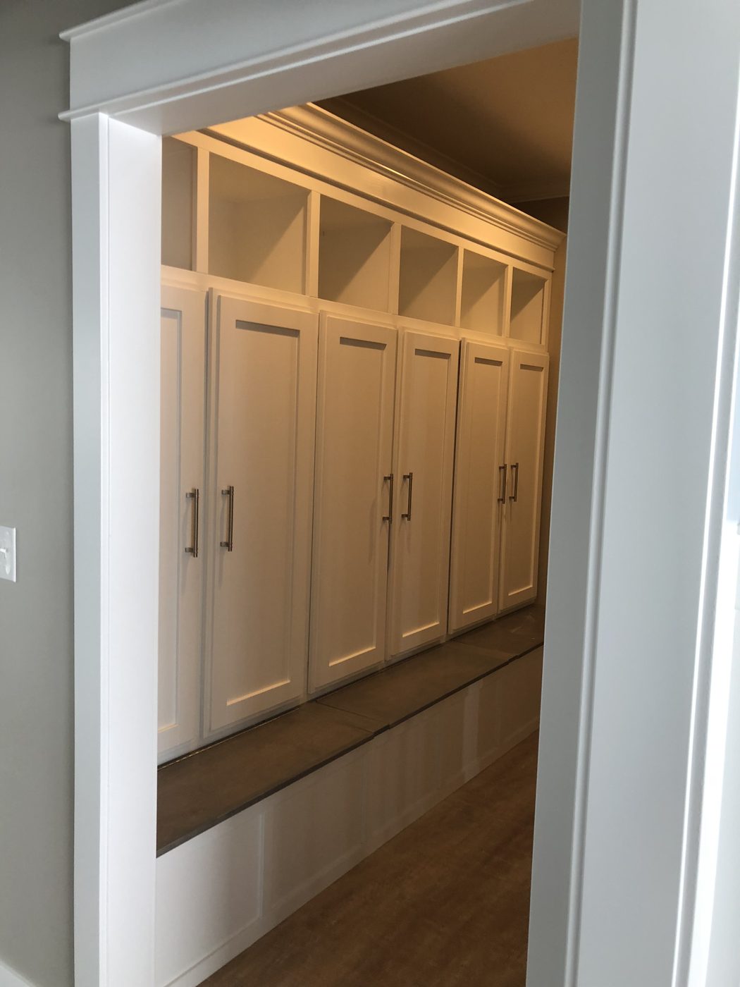 White mudroom cabinetry with built-in storage
