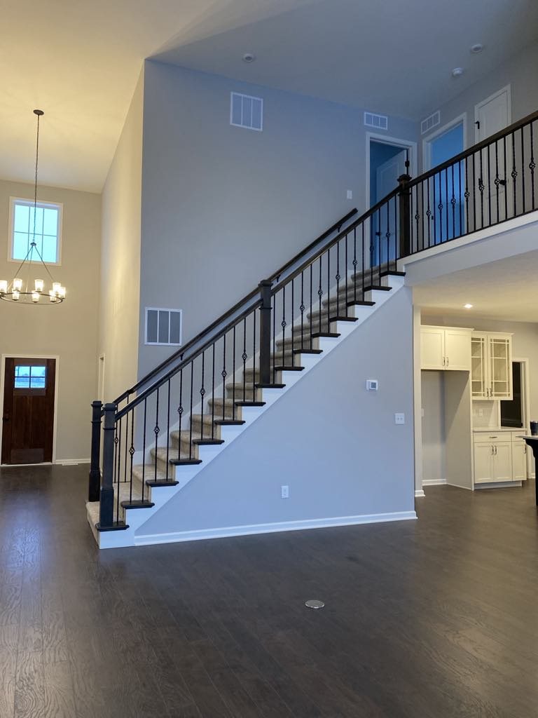 Open main floor finish carpentry package with staircase, kitchen, and trim